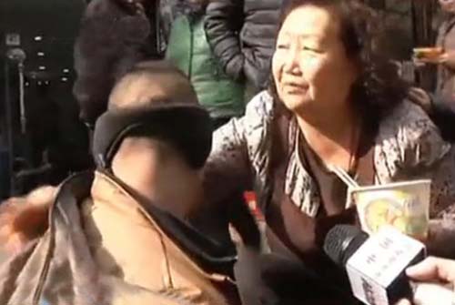 组图：大妈蹲地喂乞讨男子吃面 对方主动塞钱